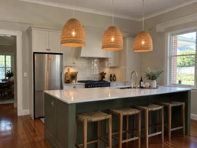 Kitchen island with three woven pendant lights, stone benchtop and timber floors in Cooranbong